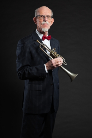 Senior jazz musician. Trumpet player. Studio shot.の写真素材