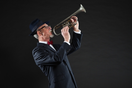 Senior jazz musician. Trumpet player. Studio shot.の写真素材