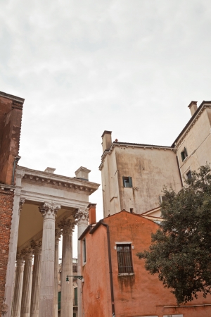 Old buildings with tree and cloudy sky in Venice. Italy.の写真素材
