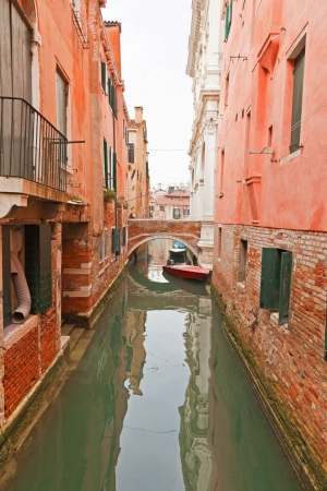 Canal with houses, bridge and boats. Venice. Italy.の写真素材