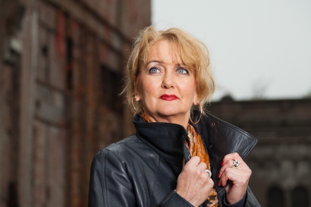 Pretty middle aged woman with blonde hair. Urban fashion.の写真素材