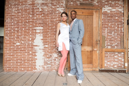 Vintage fashion romantic wedding couple in old urban building. Mixed race.の写真素材