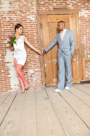 Vintage fashion romantic wedding couple in old urban building. Mixed race.の写真素材