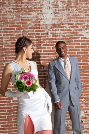 Vintage fashion romantic wedding couple in old urban building. Mixed race.の写真素材