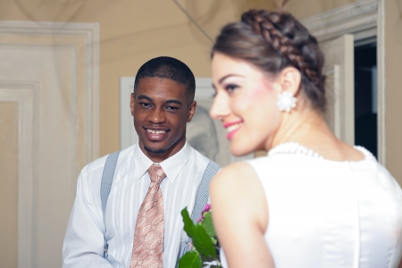 Retro fashion romantic wedding couple in old classic interior. Mixed race.の写真素材