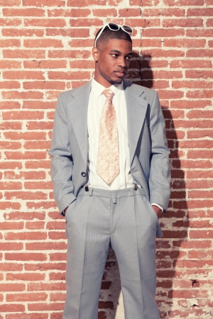 Vintage fashion cool afro american groom with sunglasses against old brick wall. Urban environment.の写真素材