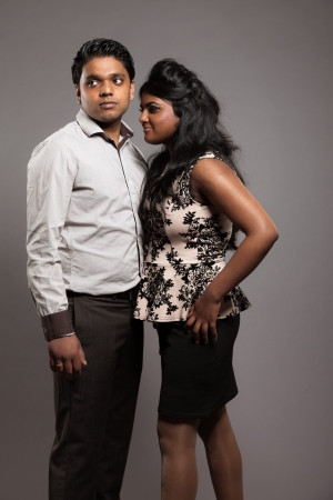 Fashionable passionate indian couple. Studio shot against grey.の写真素材