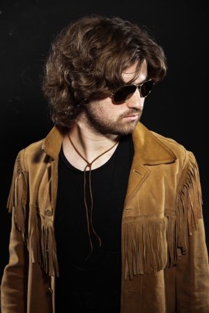 Cool rock style musician with long brown hair and beard. Wearing sunglasses.の写真素材