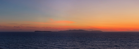 Panoramic shot of beautiful coastal sunset with some islands on the horizon  Corfu island  Greece の写真素材