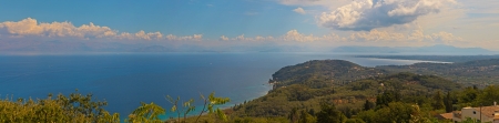 Beautiful panoramic shot of paradise bay with blue water and sky and green mountains  Corfu  Greek  Island の写真素材