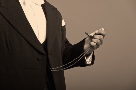 Close-up of hand of afro american man holding a vintage timepiece の写真素材