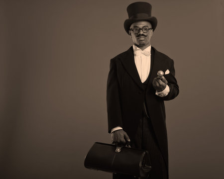Retro afro american dickens scrooge man with mustache. Wearing black hat and glasses. Holding a city...