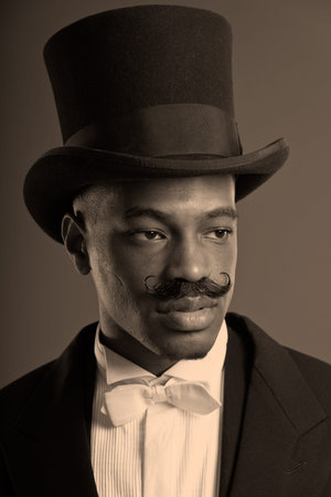Retro afro american dickens scrooge man with mustache. Wearing black hat. Close-up portrait.
