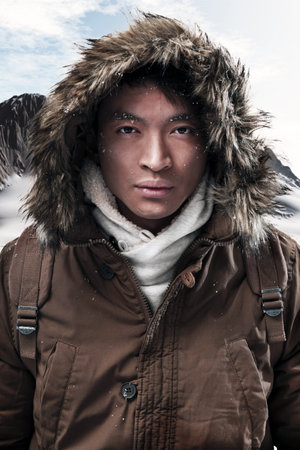 Asian winter sport fashion man with backpack in snow mountain landscape. Wearing brown jacket with...