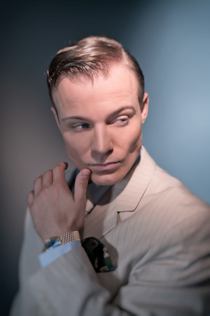 Retro 1920 business fashion man wearing white striped suit and tie. Studio shot.の写真素材