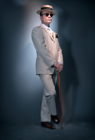 Retro classic business fashion man wearing white striped suit hat and sunglasses. Standing with cane. Studio shot.の写真素材