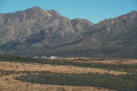 The Little Karoo semi desert with white house and mountains in the back. Western Cape. South Africa.の写真素材