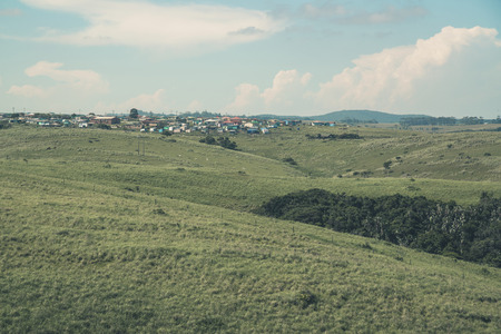 South african mountain landscape with townships under blue cloudy sky.の写真素材