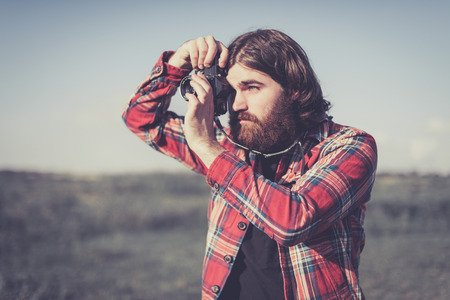 Portrait of a lone male nature photographer taking a photographの写真素材