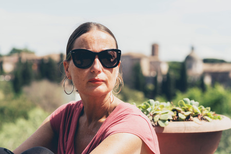 Woman with sunglasses enjoying nature outside the city of Rome.の写真素材