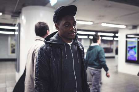 Urban fashion afro man in subway station.の写真素材