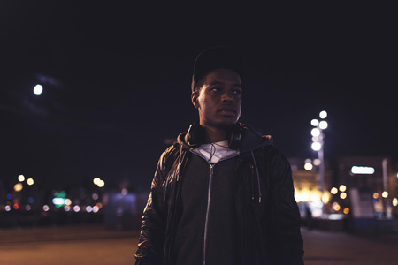 Urban fashion african american man in streets of Amsterdam at night.の写真素材