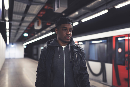 Urban fashion afro man in subway station.の写真素材