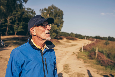 Active senior man enjoying view of heathland.の写真素材