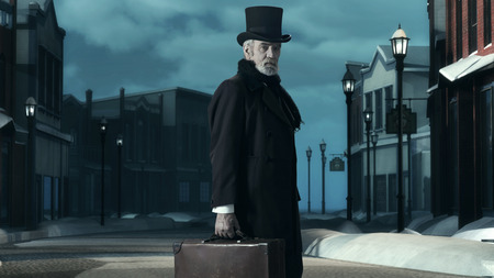 Dickens Scrooge Man in Old Winter Street. Holding Suitcase.の写真素材