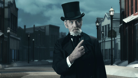 Dickens Scrooge Man in Old Winter Street. Pointing FInger.の写真素材