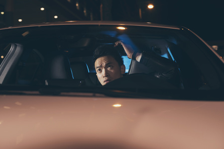 Asian man in car doing his hair.の写真素材