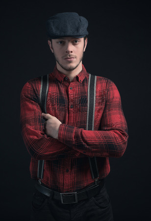 Hipster lumberjack man wearing red checkered shirt and blue cap.の写真素材