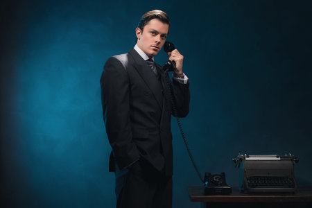 Retro 1940s business man in suit and tie on the phone.