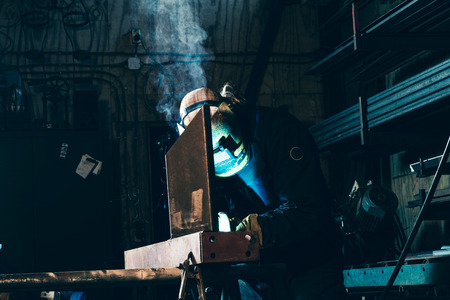 Welder in his workplace welding metalの写真素材