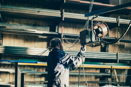 Man with beard preparing welding machineの写真素材