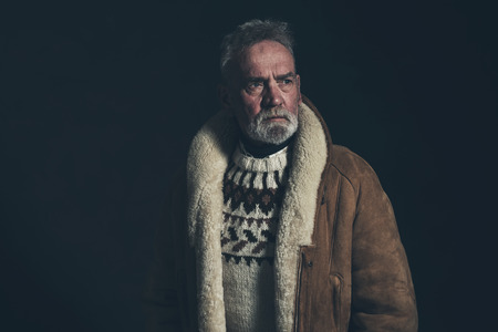 Senior man wearing knitted sweater and lambs wool coat.の写真素材