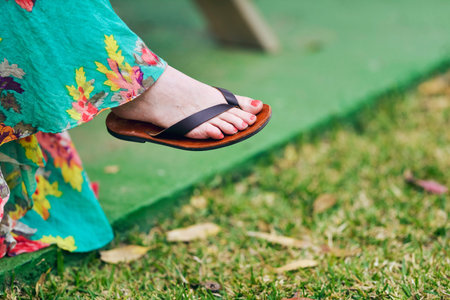 Woman foot with nail polish wearing flip-flop