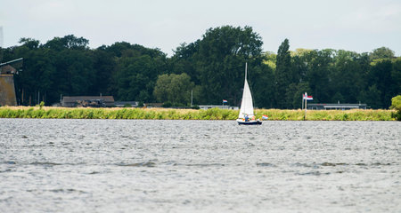 Sailboat with family in summer. The Joppe lake. Warmond. Zuid-Holland. The Netherlands.の写真素材