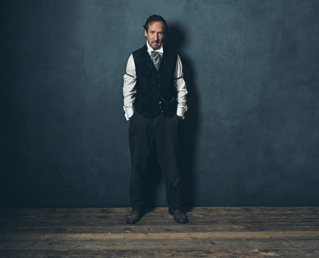Vintage 1900 western man leaning against wall.の写真素材