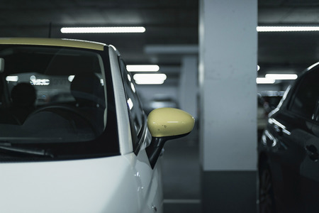 Yellow side mirror of car parked in garage.の写真素材
