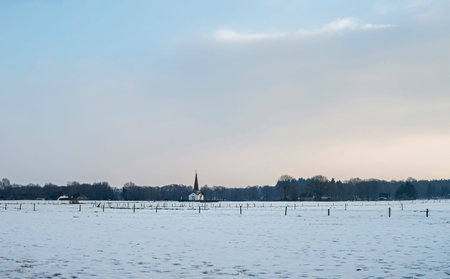 Dutch snowy winter landscape with white chapel.の写真素材