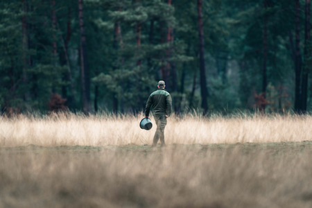 Rangers with feeding bucket in field. National Park Hoge Veluwe.の写真素材