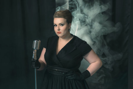Retro 1950s female singer on smoky stage with black curtain.