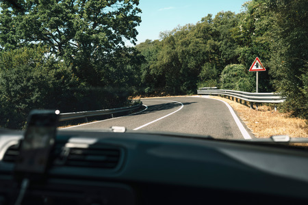 On the road during summer vacation seen through windshield.の写真素材
