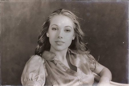 Old sepia glamour portrait of young woman in shirt.