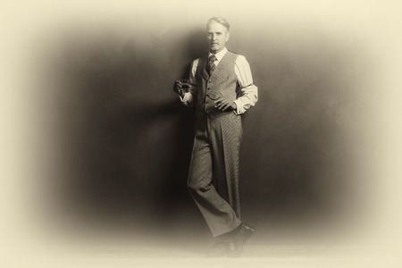 Antique plate photo of businessman 1920s style holding glass of whiskey and cigar.の写真素材