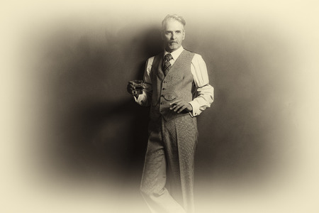 Antique plate photo of businessman 1920s style holding glass of whiskey and cigar.の写真素材