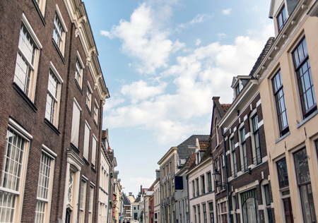 Street with old houses under blue cloudy sky. Deventer, Overijssel, Netherlands.の写真素材