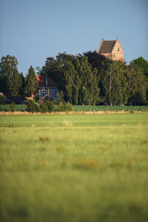 Historical church tower of country village in summer.の写真素材