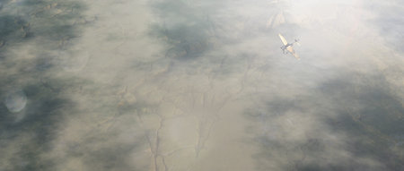 World War 2 fighter jet flying over cloudy cracked rock formations. Aerial view.